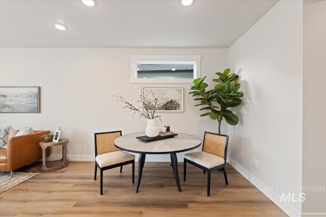 dining room with recessed lighting, wood finished floors, and baseboards