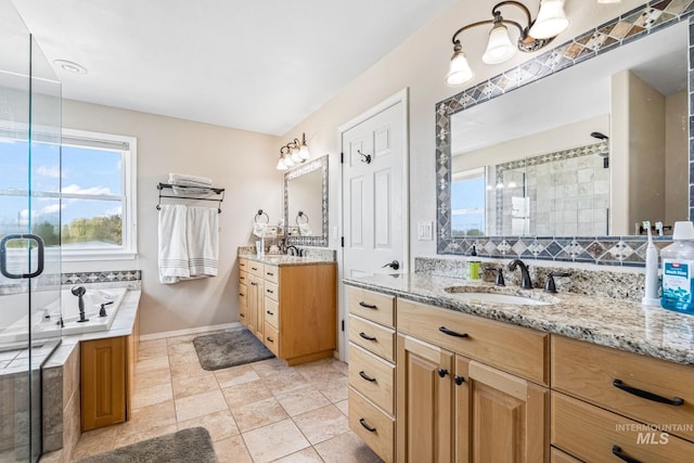 4459 E Deer Flt, Kuna, ID 83634 - full bathroom with plenty of natural light, a stall shower, two vanities, and a garden tub