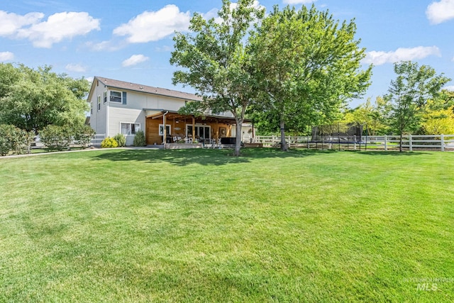 4459 E Deer Flt, Kuna, ID 83634 - fenced backyard with a trampoline and a patio area