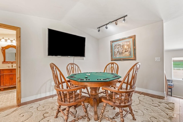 4459 E Deer Flt, Kuna, ID 83634 - dining room featuring rail lighting, wood finished floors, and vaulted ceiling
