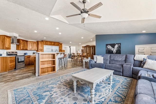 4459 E Deer Flt, Kuna, ID 83634 - living area featuring lofted ceiling, a textured ceiling, a ceiling fan, recessed lighting, and light carpet