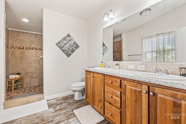 4459 E Deer Flt, Kuna, ID 83634 - bathroom featuring double vanity, a tile shower, and wood finished floors