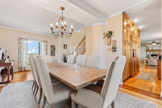 4459 E Deer Flt, Kuna, ID 83634 - dining area featuring crown molding, light wood-type flooring, a chandelier, and stairway