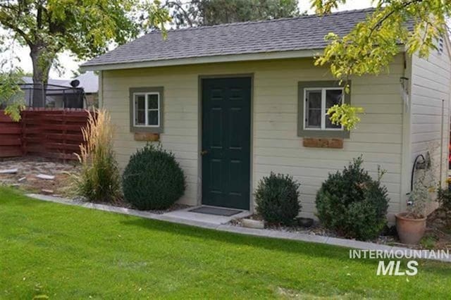 view of outbuilding with an outbuilding and fence