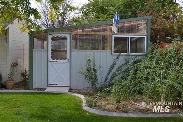 view of greenhouse featuring a yard