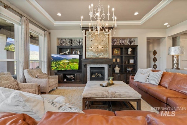 4772 W Barnview Dr, Boise, ID 83614 - living area featuring a chandelier, a tray ceiling, a large fireplace, recessed lighting, and crown molding
