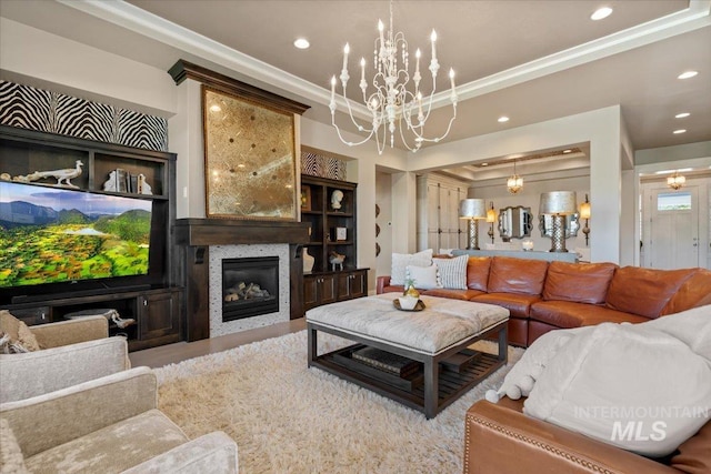 4772 W Barnview Dr, Boise, ID 83614 - living area with recessed lighting, a chandelier, a glass covered fireplace, a raised ceiling, and crown molding