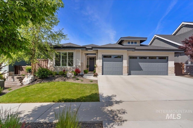 4772 W Barnview Dr, Boise, ID 83614 - view of front of house with an attached garage, concrete driveway, stone siding, and a front yard