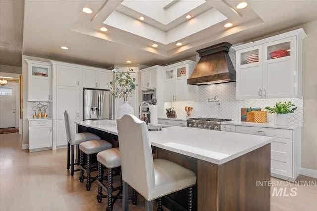 4772 W Barnview Dr, Boise, ID 83614 - kitchen featuring stainless steel appliances, custom range hood, a raised ceiling, backsplash, and recessed lighting