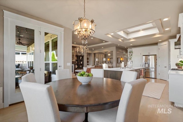 4772 W Barnview Dr, Boise, ID 83614 - dining space featuring a tray ceiling, a chandelier, and recessed lighting