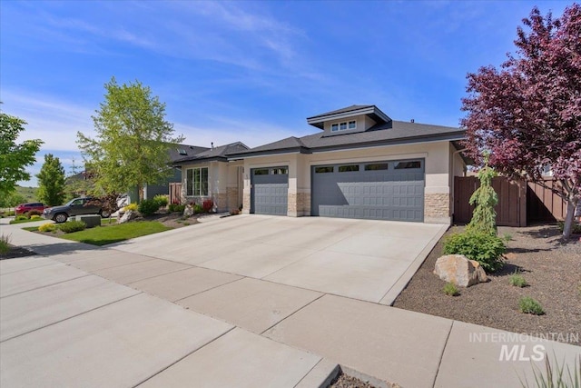 4772 W Barnview Dr, Boise, ID 83614 - prairie-style home featuring stone siding, an attached garage, and concrete driveway
