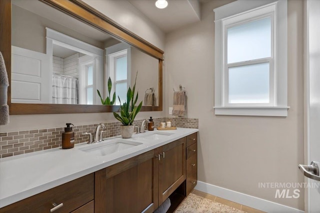 4772 W Barnview Dr, Boise, ID 83614 - full bath featuring double vanity, decorative backsplash, baseboards, and tile patterned floors