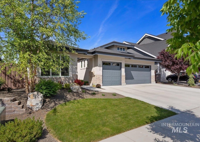 4772 W Barnview Dr, Boise, ID 83614 - view of front of property with an attached garage, driveway, stone siding, and stucco siding