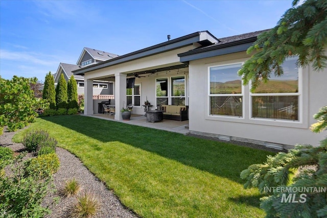 4772 W Barnview Dr, Boise, ID 83614 - back of house with a ceiling fan, a patio area, an outdoor hangout area, a lawn, and stucco siding