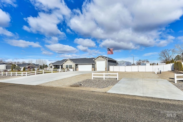 view of front of home with a garage, fence, and driveway