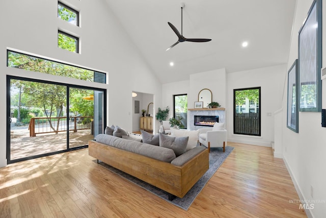 1435 N Garden, Boise, ID 83706 - living room featuring high vaulted ceiling, light wood-style floors, ceiling fan, a glass covered fireplace, and baseboards