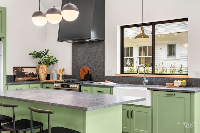1435 N Garden, Boise, ID 83706 - kitchen featuring green cabinets, wall chimney exhaust hood, a sink, stainless steel gas range, and tasteful backsplash