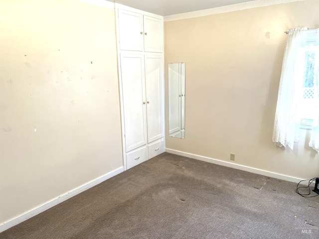 unfurnished bedroom featuring carpet flooring and a closet