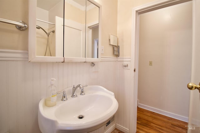 bathroom featuring sink, hardwood / wood-style floors, and walk in shower