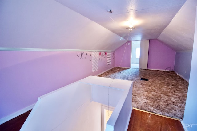 bonus room featuring lofted ceiling and dark wood-type flooring