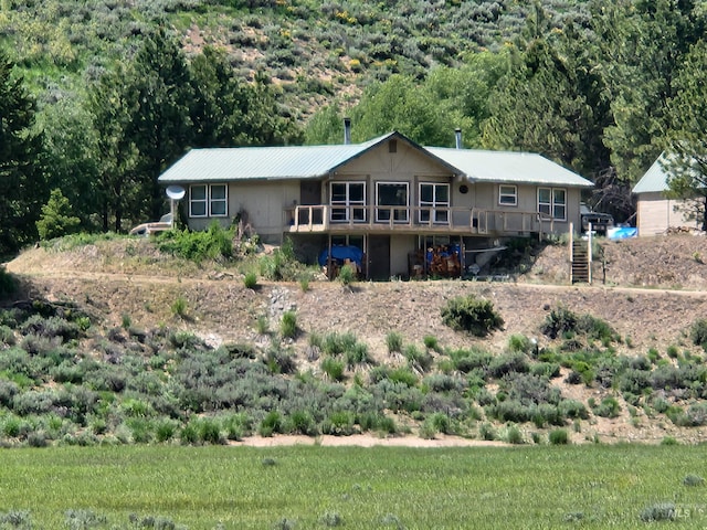4942 E Baumgartner Rd, Featherville, ID 83647 - rear view of property with a deck, a forest view, and stairs
