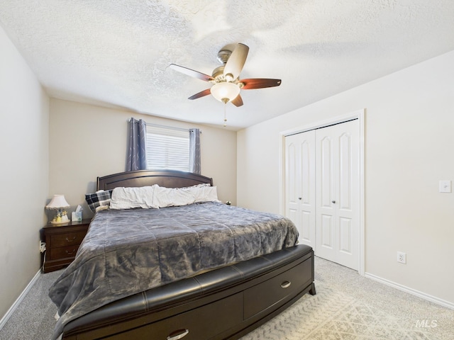 bedroom with baseboards, light carpet, and a closet