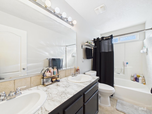 full bath with a sink, visible vents, toilet, and double vanity