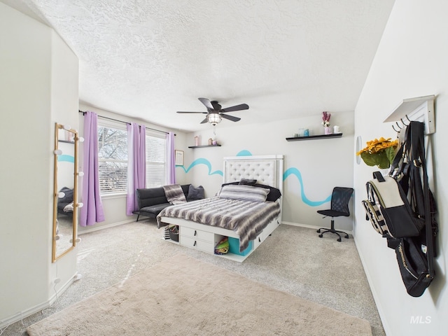 bedroom featuring baseboards, carpet, ceiling fan, and a textured ceiling