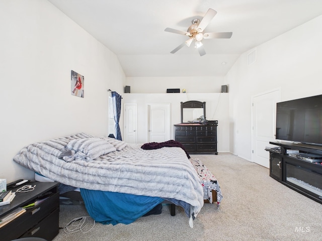 bedroom with visible vents, carpet, ceiling fan, and vaulted ceiling