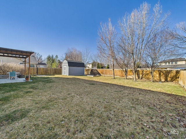 view of yard featuring an outbuilding, a fenced backyard, a storage shed, and a patio