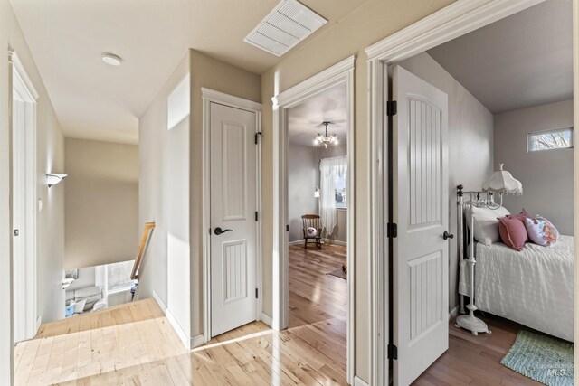 hallway with wood finished floors and baseboards