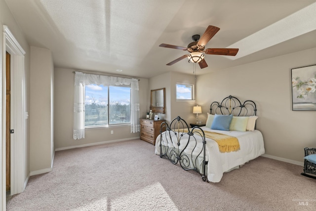 bedroom featuring baseboards, light carpet, and ceiling fan