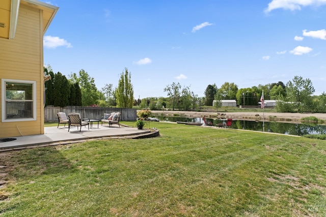 view of yard featuring a patio area and a water view