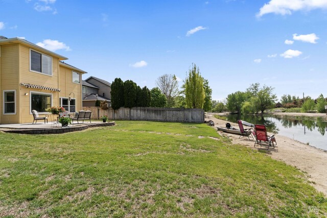 view of yard featuring a patio area and a water view