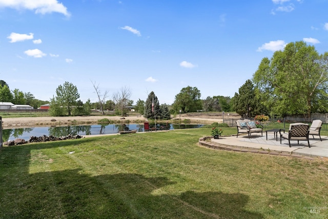 view of yard featuring a water view and a patio