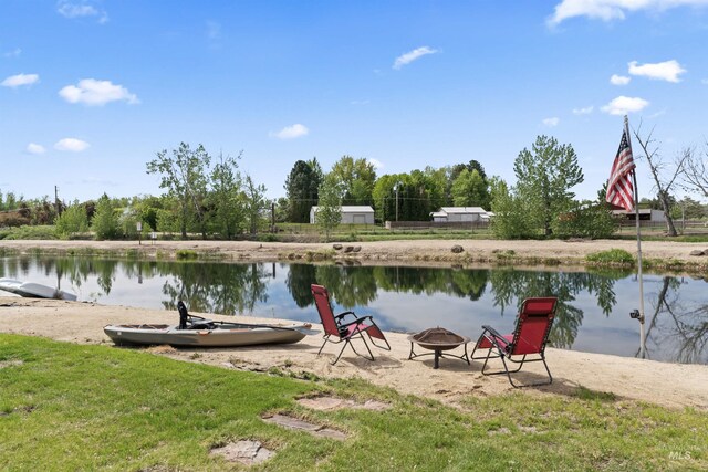 dock area featuring a fire pit and a water view