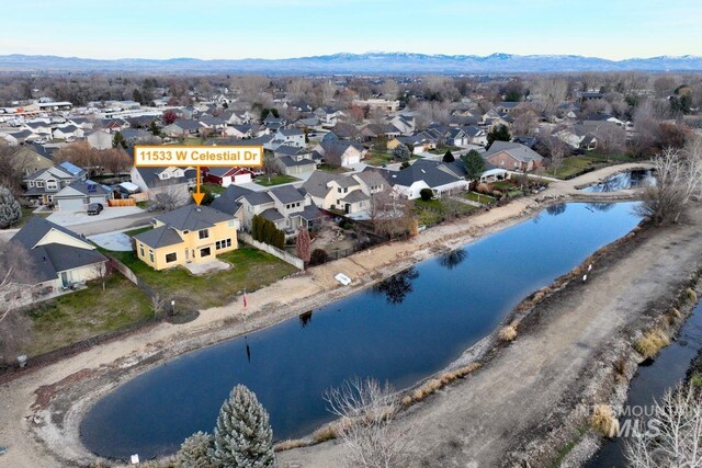 aerial perspective of suburban area featuring a water and mountain view
