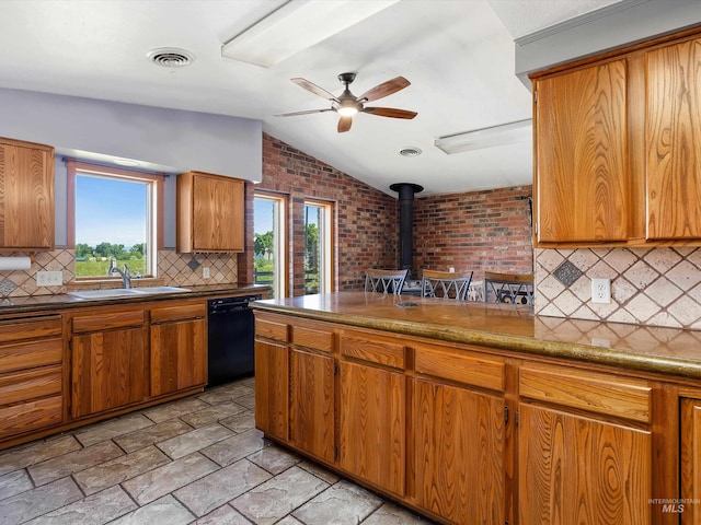 1872 E 1750 S, Gooding, ID 83330 - kitchen featuring black dishwasher, a sink, a wood stove, brown cabinetry, and vaulted ceiling