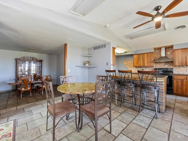 1872 E 1750 S, Gooding, ID 83330 - dining area with stone tile floors, vaulted ceiling, and ceiling fan