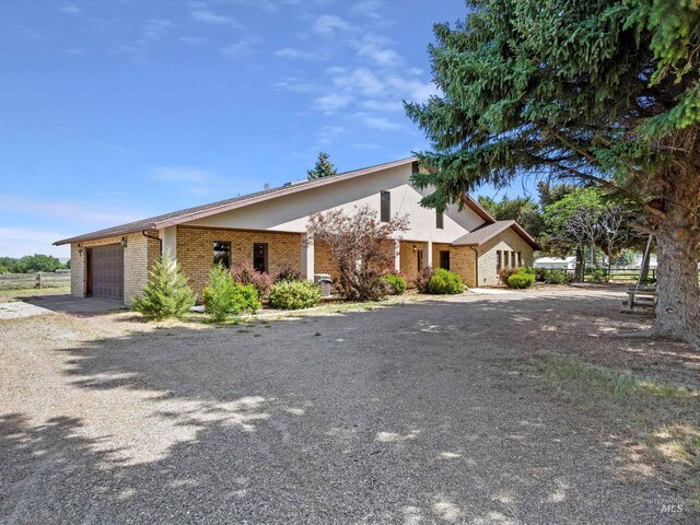 1872 E 1750 S, Gooding, ID 83330 - view of front of property featuring an attached garage, gravel driveway, and brick siding