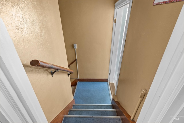 stairs featuring baseboards