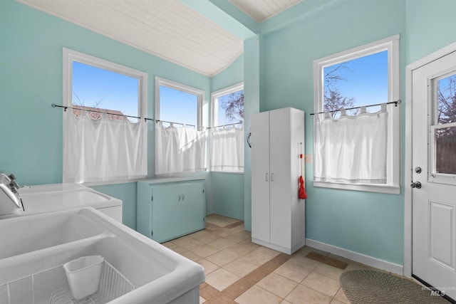 interior space featuring tile patterned floors, vanity, baseboards, and independent washer and dryer