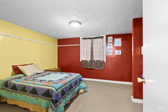 carpeted bedroom with baseboards and a textured ceiling