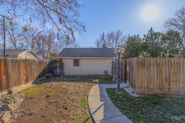 view of yard with an outdoor structure and a fenced backyard