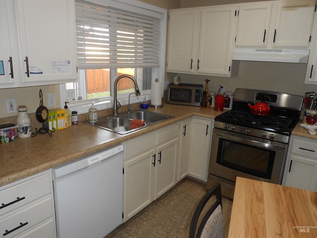 kitchen featuring light tile patterned floors, sink, white cabinets, and stainless steel appliances