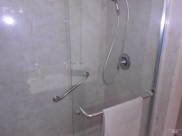 bathroom with a shower with door