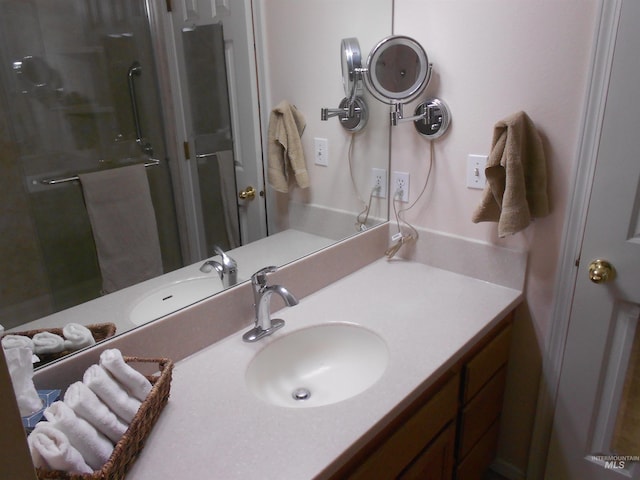 bathroom featuring an enclosed shower and vanity