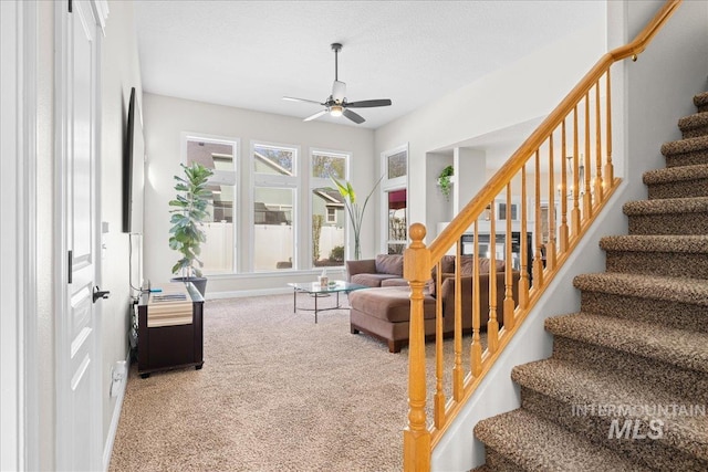 605 W Highland Ave, Nampa, ID 83686 - living room featuring stairs, a ceiling fan, carpet flooring, and baseboards