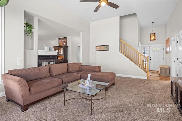605 W Highland Ave, Nampa, ID 83686 - carpeted living area with ceiling fan, baseboards, stairway, and a towering ceiling
