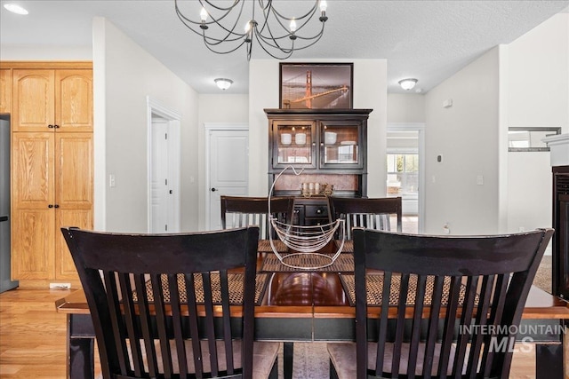 605 W Highland Ave, Nampa, ID 83686 - dining room featuring a chandelier and light wood-style flooring